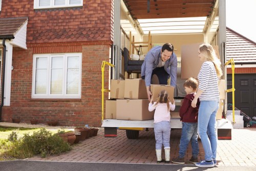 Professional movers loading items into a moving truck in Maidavale